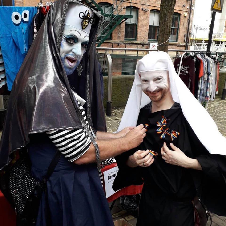 Sister BangBang pinning ribbons onto Postulant Mona